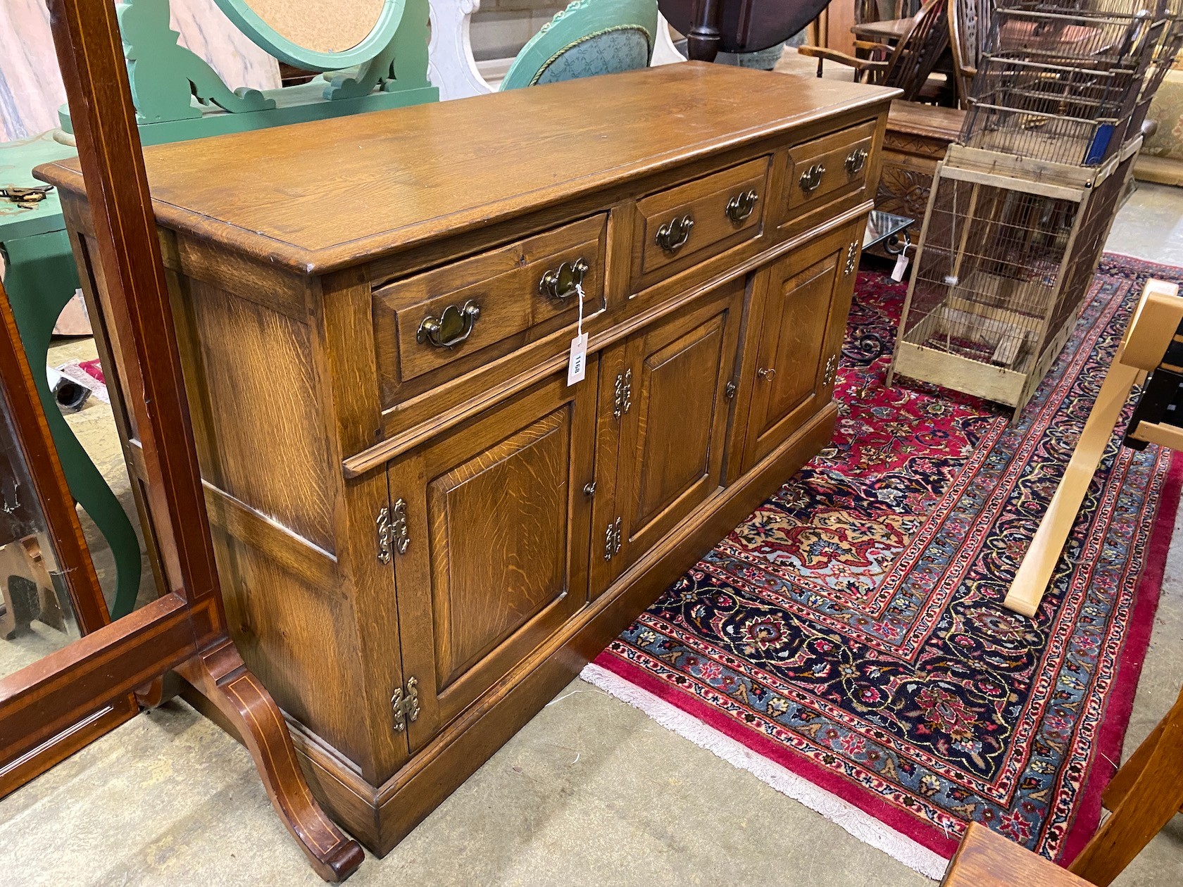 A reproduction 18th century style oak low dresser, fitted three drawers over three cupboards, length 152cm, width 50cm, height 85cm